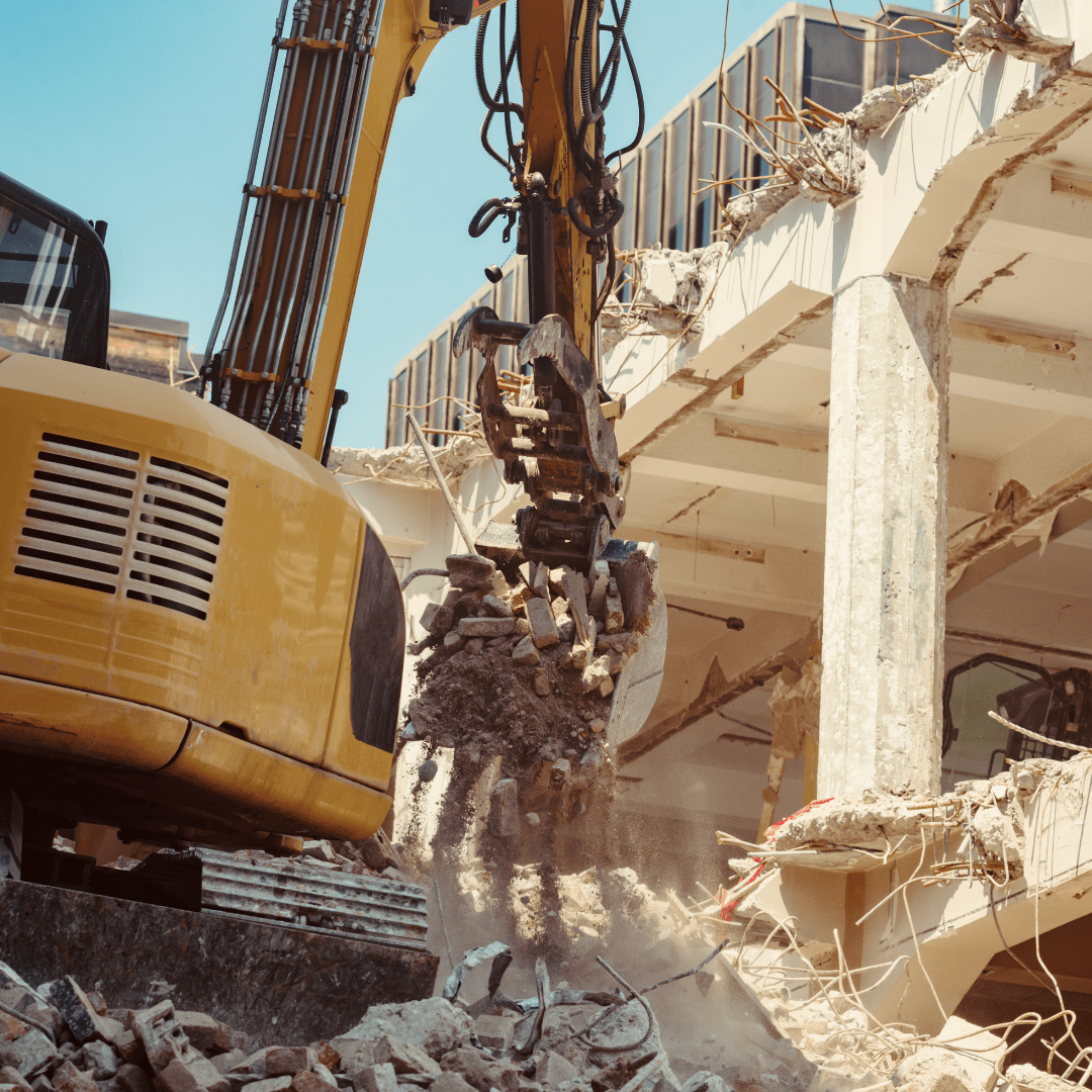 Màquina treballan la demolició d'un edifici per reconstruir